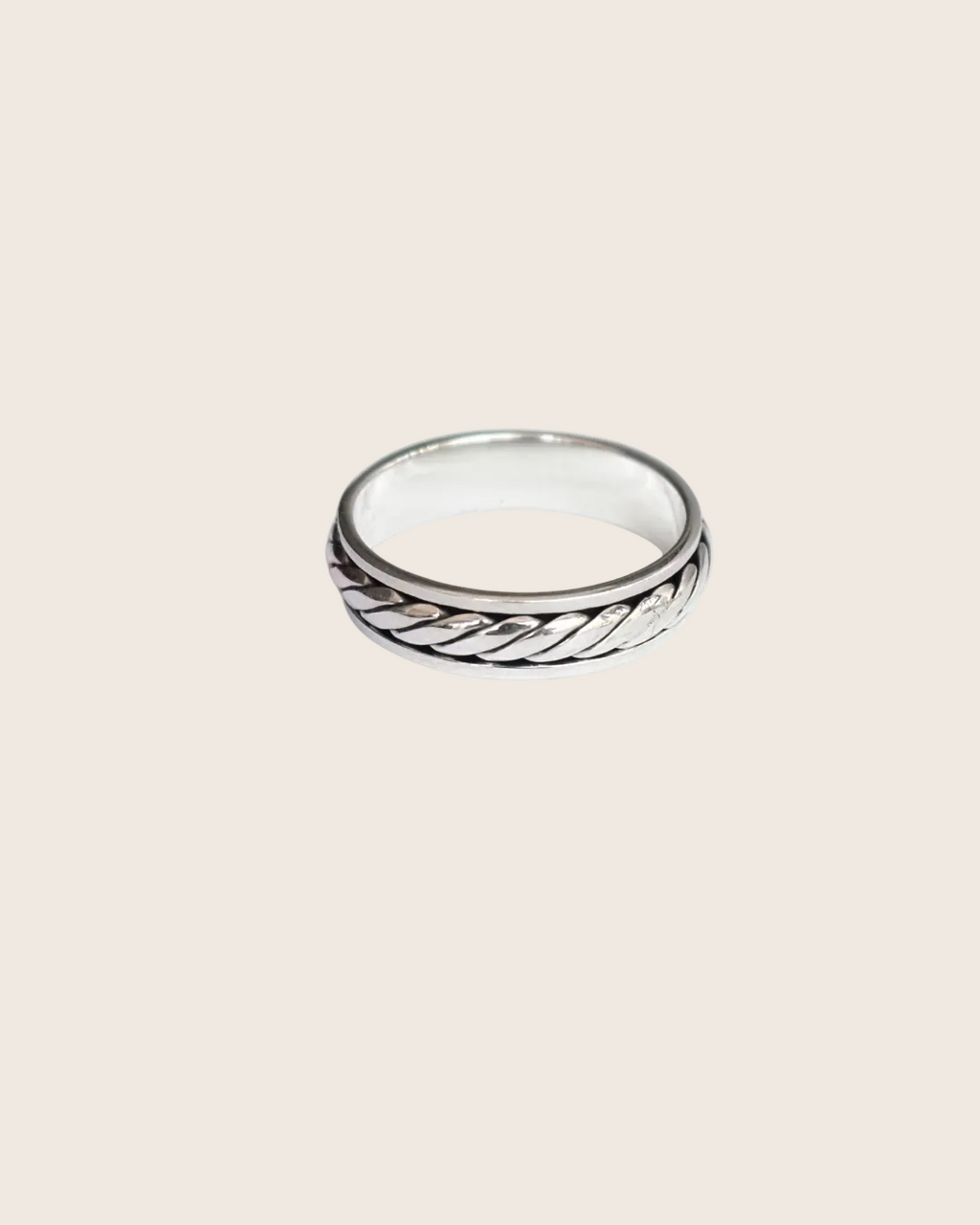 Silver ring with a textured design on a white background