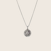 Silver necklace with a round pendant on a white background